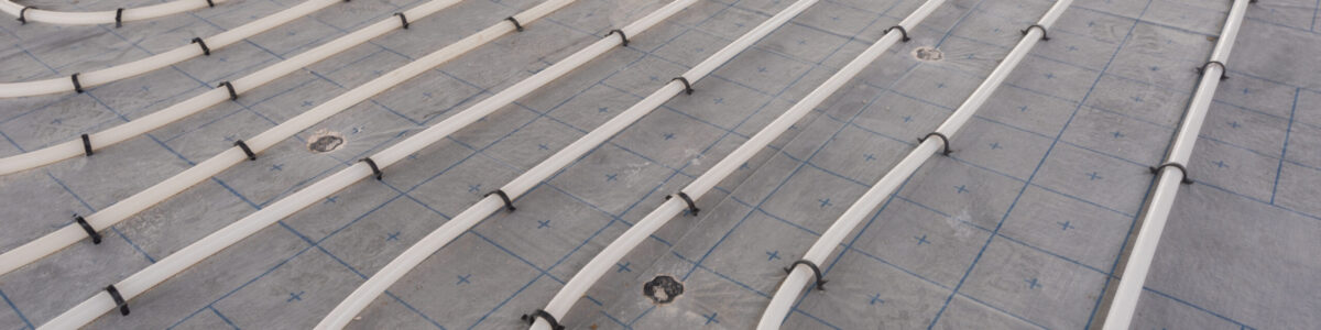 Underfloor heating system installation. Close up on water floor heating system interior of a new indoor swimming pool and SPA center. Plumbing pipes. Individual Heating.